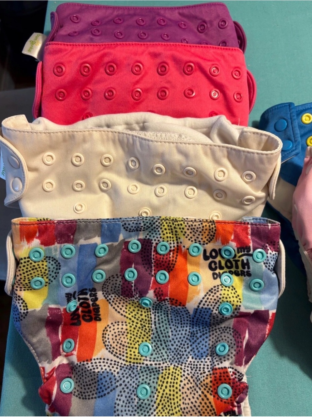 Set of 10 cloth baby diapers from Alvababy and 3 other brands.